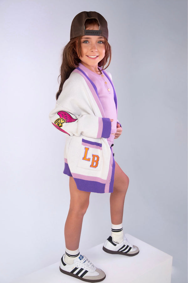 Girl in the purple Alpha Haus cardigan by Little Baddie