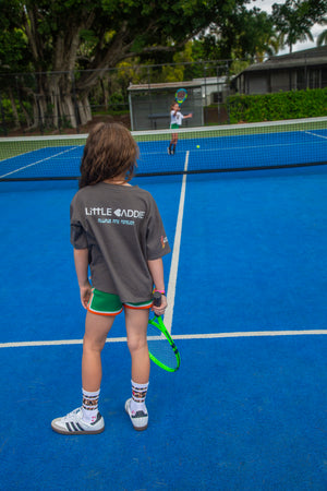 Girls Palm Beach Playground graphic tee by Little Baddie, stylish casual t-shirt for girls aged 5 to 12, backside , girl playing tennis